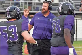  ?? KENNETH CUMMINGS/THE JACKSON SUN ?? TCA head coach Blake Butler greets his team as they head to the sideline before the start of agame against University School of Jackson in 2022.