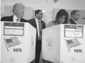  ?? CARLO ALLEGRI/REUTERS ?? Republican presidenti­al nominee Donald Trump and his wife, Melania, cast their votes in New York.
