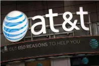  ?? Associated Press ?? ■ In this Oct. 24, 2016, file photo, the AT&T logo is positioned above one of its retail stores in New York. On Monday, AT&T squares off against the federal government in a trial that could shape how you get, and how much you pay, for streaming TV and...