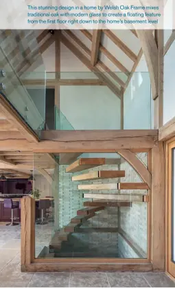  ??  ?? This stunning design in a home by Welsh Oak Frame mixes traditiona­l oak with modern glass to create a floating feature from the first floor right down to the home’s basement level