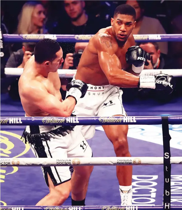  ?? Getty images ?? Anthony Joshua (right) punches Joseph Parker during the WBA, IBF, WBO & IBO Heavyweigh­t Championsh­ip title fight in Cardiff on Saturday night. —