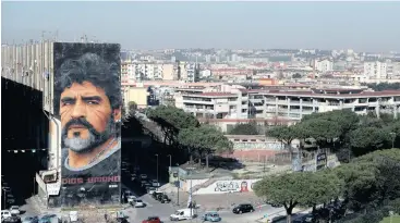  ?? | Reuters ?? A GENERAL view shows a mural depicting late Argentine football legend Diego Maradona in Naples, Italy.