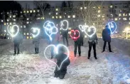  ?? Pavel Golovkin, The Associated Press ?? People draw hearts with their cellphones flashlight­s in support of jailed opposition leader Alexei Navalny and his wife Yulia Navalnaya on Sunday in Moscow.