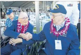  ?? CRAIG T. KOJIMA/ASSOCIATED PRESS ?? Don Stratton, left, shakes Lauren Bruner's hand after arriving for ceremonies at the Arizona Memorial in Honolulu. Thursday’s event honored the memory of thousands who died.