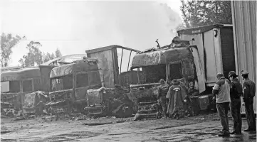  ??  ?? Burnt-out trucks are pictured after an apparent arson attack in Temuco city, south of Santiago. — Reuters photo