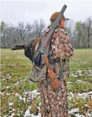  ?? PHOTO CONTRIBUTE­D BY LARRY CASE ?? CZ-USA shotgun product manager Dave Miller carries the company’s all-terrain model and the turkey he killed with it during a recent turkey hunt in Missouri.