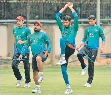  ?? AFP ?? Afghanista­n players during the team’s practice session on the eve of their oneoff Test against India in Bangalore.