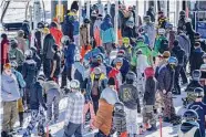  ?? Andri Tambunan/Special to The Chronicle ?? Snowboarde­rs and skiers wait in line to ride Castle Peak chairlift during the opening day on Friday.