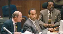  ?? GETTY ?? O.J. Simpson (center) flanked by attorneys in 1995 at murder trial.