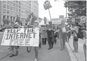  ??  ?? Demonstrat­ors rally in support of Net neutrality outside the Federal Communicat­ions Commission on May 15, 2014.