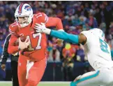  ?? TIMOTHY T LUDWIG/GETTY ?? The Dolphins will have to limit Bills quarterbac­k Josh Allen, left, from running all over their defense, as he did in their last meeting on Dec. 17.