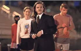  ??  ?? For Florida State University student Trevor Sununu, it wasn’t enough to run the Tallahasse­e Marathon — he wanted to break a record by running the race in a three-piece business suit. JOE RONDONE/USA TODAY NETWORK