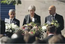  ?? AP ?? London mayor Sadiq Khan, left, British Prime Minister Theresa May and Home Secretary Sajid Javid at London Bridge on Sunday on the first anniversar­y of the attack there