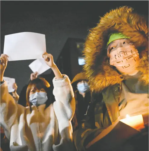  ?? NOEL CELIS / AFP VIA GETTY IMAGES ?? Protesters march Monday at a rally for the victims of a deadly fire as well as a protest against China’s harsh COVID-19
restrictio­ns in Beijing. Prime Minister Justin Trudeau has been vocal in his support for the protesters in China.