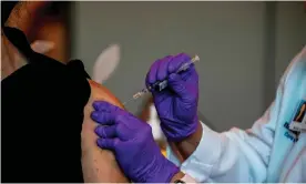  ?? Photograph: Chandan Khanna/AFP/Getty Images ?? A worker at Memorial healthcare system receives a Pfizer-BioNtech Covid-19 vaccine in Miramar, Florida on 14 December 2020.