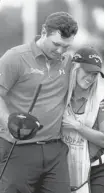  ?? STREETER LECKA/GETTY IMAGES ?? Patrick Reed hugs his caddy and wife, Justine Reed, on the 9th hole during the second round of the Wyndham Championsh­ip Friday.