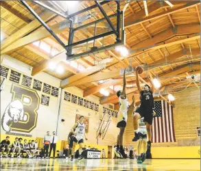  ?? Matthew Brown / Hearst Connecticu­t Media ?? Brunswick’s Henry Caponiti (35) drives in for two points against Hamden Hall in an FAA boys basketball game at Brunswick School on Friday in Greenwich. Hamden Hall defeated Brunswick 59-58.