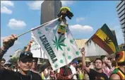  ?? Yuri Cortez AFP/Getty Images ?? ACTIVISTS march along Reforma Avenue in Mexico City calling for marijuana legalizati­on in May 2017.