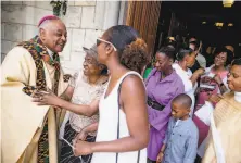  ?? Andrew Harnik / Associated Press 2019 ?? Archbishop Wilton Gregory greets parishione­rs last year at St. Augustine Church in Washington. Gregory will be the first Black U. S. prelate to assume the rank of cardinal.