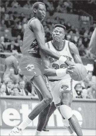  ?? Jim Sulley Associated Press ?? MANUTE BOL, at 7-foot-7, dwarfed centers like Patrick Ewing and was most accomplish­ed as a shot blocker, but he liked to shoot threes and, for one night at least, he was really good at it.