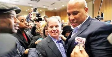  ??  ?? Jones campaigns with Sen Cory Booker during a campaign event held at Alabama State University at the John Garrick Hardy University Student Center in Montgomery, Alabama. — AFP photo