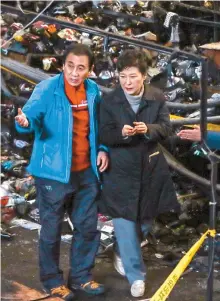  ?? Yonhap ?? President Park Geun-hye looks around Seomun Market in her hometown of Daegu, Thursday, after part of it was burned to the ground by a huge fire a day earlier. The visit is Park’s first scheduled outing in 35 days, following the eruption of an...