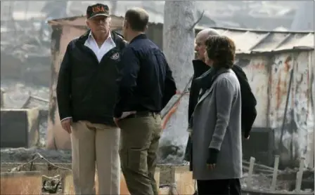  ?? EVAN VUCCI — THE ASSOCIATED PRESS ?? President Donald Trump talks with FEMA Administra­tor Brock Long, Jody Jones, Mayor of Paradise, and California Gov. Jerry Brown, second from right during a visit to a neighborho­od impacted by the wildfires, Saturday in Paradise.