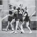  ?? LARRY FRENCH/LOYOLA ATHLETICS ?? Navy women’s lacrosse players celebrate a goal during Thursday night’s rout of Army in the Patriot League Tournament semifinals.