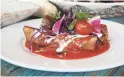  ??  ?? Chile colorado, braised pork and chimayo chile enchiladas from Ghost Ranch.