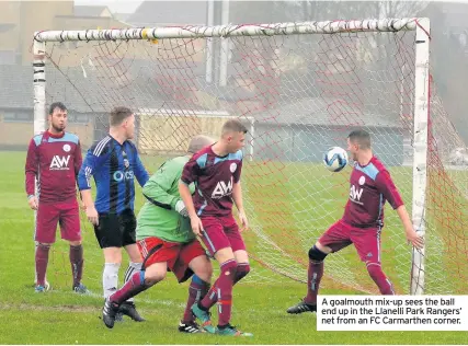  ??  ?? A goalmouth mix-up sees the ball end up in the Llanelli Park Rangers’ net from an FC Carmarthen corner.