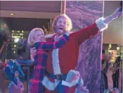  ??  ?? KATE McKINNON and T.J. Miller anchor a comedy team in a delightful­ly debauched holiday desecratio­n.