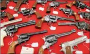  ?? LAUREN HALLIGAN LHALLIGAN@DIGITALFIR­STMEDIA.COM ?? Guns are displayed at the last day of the final New Eastcoast Arms Collectors Associates Arms Fair held at the Saratoga Springs City Center.