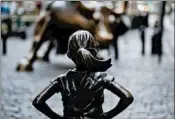  ?? JEENAH MOON/BLOOMBERG 2017 ?? State Street Global Advisors installed “Fearless Girl” in front of “Charging Bull” on Wall Street one year ago.