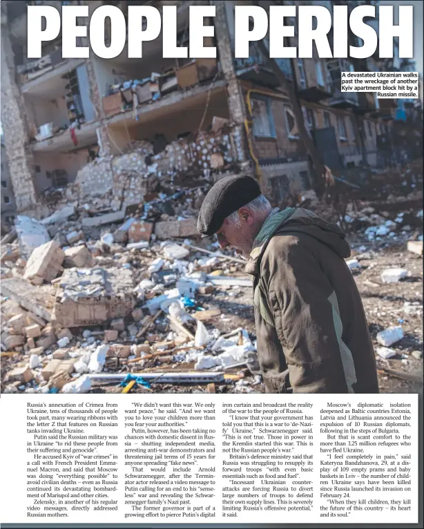  ?? ?? A devastated Ukrainian walks past the wreckage of another Kyiv apartment block hit by a Russian missile.