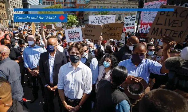  ?? Adam Scotti photo ?? Prime Minister Justin Trudeau (centre) and Minister of Social Developmen­t Ahmed Hussen (left) attend a racial justice protest on Parliament Hill on June 5, 2020.