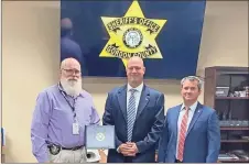  ?? Contribute­d ?? Gordon County Sheriff’s Office Detective Kenneth Holaran recently received an FBI commendati­on. Pictured are Hollaran (from left), and FBI Agents Jamie Harter, and Sean Burke.