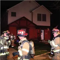  ??  ?? Royal Oak firefighte­rs near the front of the house on Chippewa where a detached garage was destroyed by fire Sunday evening.