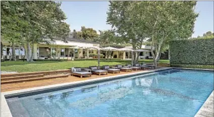  ??  ?? PATIOS ARE nestled behind the Beverly Hills home, descending to a pool with city views at the edge of the property. Seacrest bought the compound from Ellen DeGeneres eight years ago.