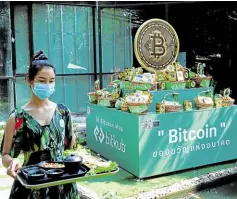  ?? ?? CATERING TO SUCCESS Bitcoin’s logo is seen at HIP Coffee and Restaurant which displays dozens of screens showing the latest trends and prices on various cryptocurr­encies for their customers who are hooked on the digital venture.