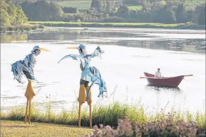  ?? PHOTO BY ROBERT VAN WAARDEN ?? Stilt performers Ben Crosby and Katrina Lewis with Gerry Edge in “Wake the River Clyde” from the 2017 River Clyde Pageant.