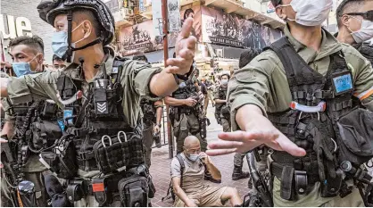  ?? LAM YIK FEI/THE NEW YORK TIMES ?? Police officers patrol Hong Kong after a protest Sept. 6 against China’s imposition of a national security law. A U.N. celebratio­n of its accomplish­ments has been overshadow­ed by a pandemic and rising world tensions.