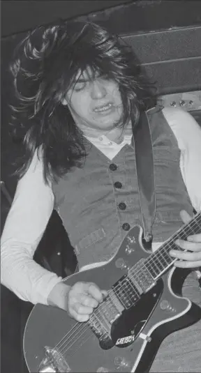  ?? MICHAEL PUTLAND, GETTY IMAGES ?? Malcolm Young performing with AC/DC at the Marquee Club, London, in 1976. Young who helped create anthems “Highway to Hell,” “Hells Bells” and “Back in Black,” has died at 64.