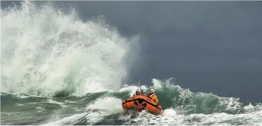  ??  ?? Trearddur Bay D-Class lifeboat battles in the rough seas. Pic by Nigel Millard