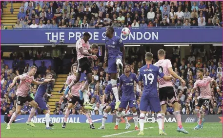  ??  ?? Leicester City’s Wilfred Ndidi ( in flight, left), heading from a corner kick to equalise 1- 1 against Chelsea at Stamford Bridge...yesterday