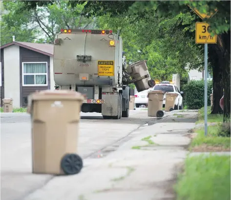  ?? BRANDON HARDER ?? A City of Regina garbage truck collects trash in the Glencairn neighbourh­ood. The city is looking to change its garbage system.