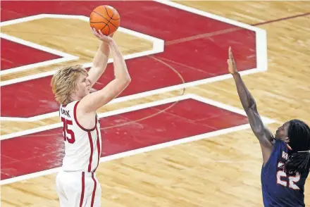  ??  ?? Oklahoma's Brady Manek (35) shoots a basket over UTSA's Keaton Wallace (22) during the Sooners' 105-66 win on Dec. 3 at Lloyd Noble Center in Norman. Manek is expected to return from COVID protocol on Tuesday against Kansas State. [BRYAN TERRY/ THE OKLAHOMAN]