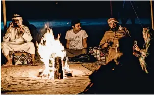  ??  ?? STORYTELLI­NG UNDER THE STARS: After a long day out in the dunes of Abu Dhabi, participan­ts of this year’s Camel Trek gather around a campfire to hear stories about how Bedouins lived in the desert and survived the harsh natural conditions. —
Photos by Neeraj Murali