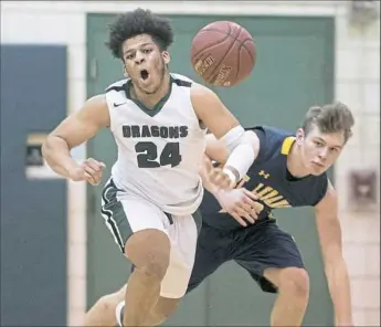  ?? Steph Chambers/Post-Gazette ?? Allderdice’s Tyler Williams, left, and Mt. Lebanon’s Mike Palmer go after a loose ball.