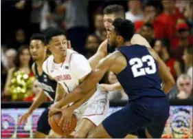  ?? PATRICK SEMANSKY — THE ASSOCIATED PRESS ?? Maryland’s Anthony Cowan Jr., left, tries to maintain possession as he is pressured by Penn State’s Josh Reaves (23) and Strath Haven AllDelco John Harrar Saturday in College Park, Md.