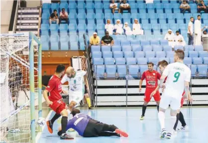  ??  ?? Emirates Driving Institute’s Sabry Jameel (8) scores in their 9-2 rout of The Storm in a quarter-final match of the NAS Futsal Championsh­ip.